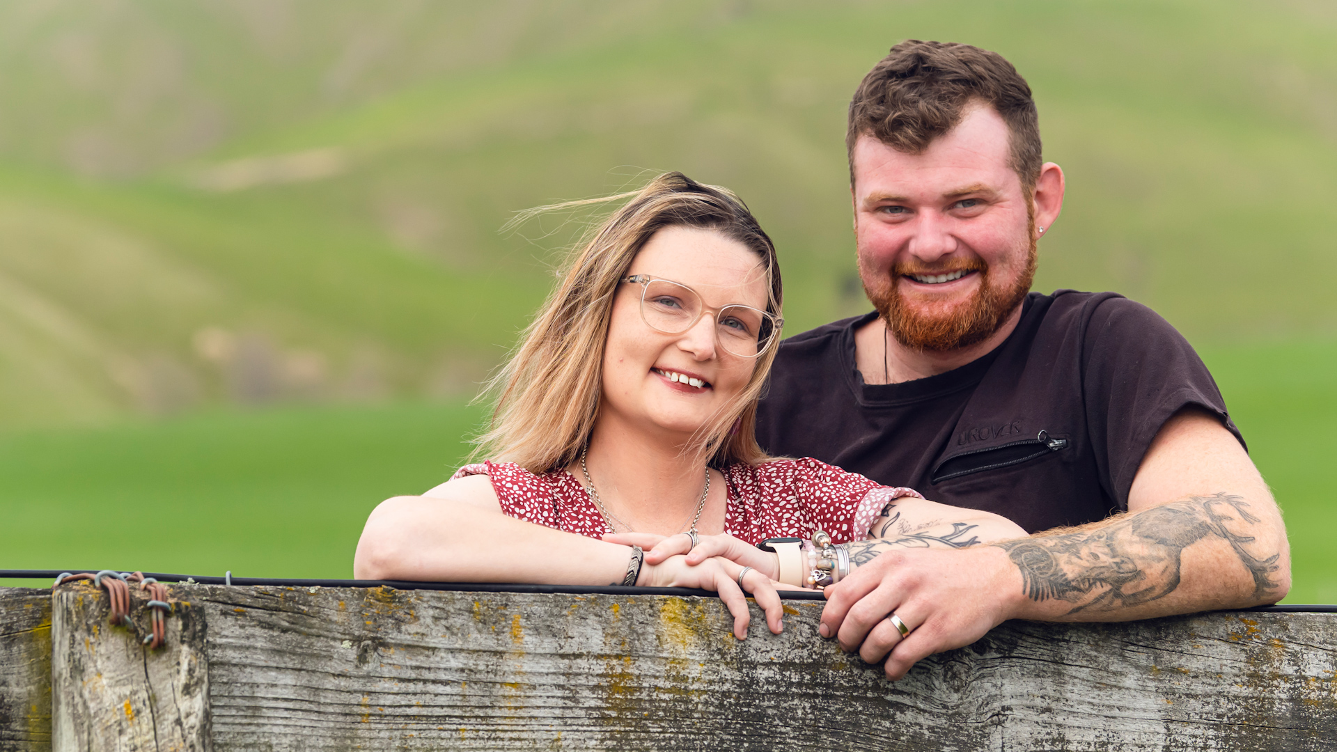 Anastasia and her husband smiling at camera