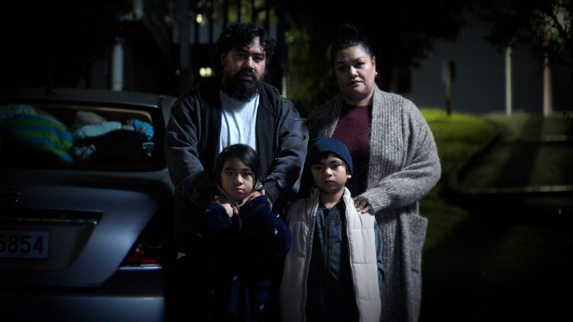 Family stood in front of a car